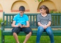 Teenage girl looking with love at indifferent boy Royalty Free Stock Photo