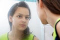 Teenage girl looking in mirror Royalty Free Stock Photo