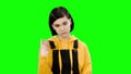 Teenage girl looks forward angrily. Green screen