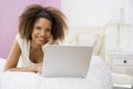 Teenage Girl Lying On Bed Using Laptop Royalty Free Stock Photo