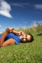 Teenage girl lying on grass with mp3 player Royalty Free Stock Photo