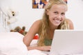 Teenage Girl Lying On Her Bed Using Laptop Royalty Free Stock Photo