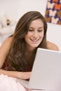 Teenage Girl Lying On Her Bed Using Laptop Royalty Free Stock Photo