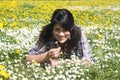 Teenage girl lying in spring meadow Royalty Free Stock Photo