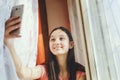 A teenage girl makes selfie on a cell phone