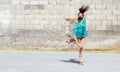 Teenage girl in mask performing figure skating spin