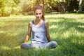 Teenage girl meditates in nature