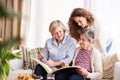 A teenage girl, mother and grandmother at home. Royalty Free Stock Photo