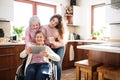 A teenage girl with mother and grandmother at home. Royalty Free Stock Photo