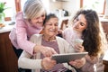 A teenage girl with mother and grandmother at home. Royalty Free Stock Photo