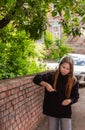 teenage girl outdoors playing with maple seeds as launching helicopters on summer evening