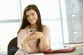 Teenage girl with phone in class Royalty Free Stock Photo