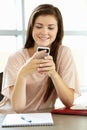 Teenage girl with phone in class Royalty Free Stock Photo