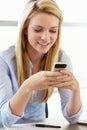 Teenage girl with phone in class Royalty Free Stock Photo