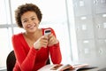 Teenage girl with phone in class Royalty Free Stock Photo