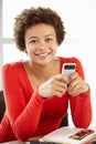 Teenage girl with phone in class Royalty Free Stock Photo