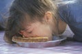 Teenage girl in a pie-eating contest, Royalty Free Stock Photo