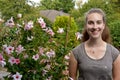 Teenage girl and pink mandevilla