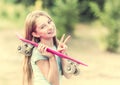 Teenage girl with pink skateboard smiling