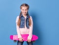 Teenage girl with pink skateboard