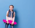 Teenage girl with pink skateboard