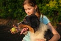 teenage girl play with australian shepherd puppy dog in summer. in forest Royalty Free Stock Photo