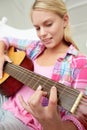Teenage girl playing acoustic guitar Royalty Free Stock Photo