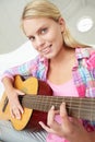 Teenage girl playing acoustic guitar Royalty Free Stock Photo