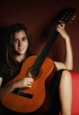 Teenage girl playing an acoustic guitar Royalty Free Stock Photo