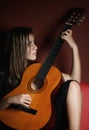 Teenage girl playing an acoustic guitar Royalty Free Stock Photo