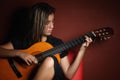 Teenage girl playing an acoustic guitar Royalty Free Stock Photo