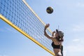 Teenage girl playing beach volleyball. Beach volleyball championship. woman reaches for the ball. throwing a yellow volleyball Royalty Free Stock Photo