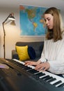 Teenage girl playing electronic musical instrument