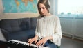 Teenage girl playing electronic piano