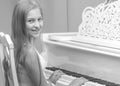 A teenage girl is playing on a white grand piano. Royalty Free Stock Photo