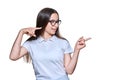 Teenage girl pointing fingers to the side at space for text, on white isolated background Royalty Free Stock Photo