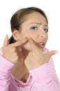 Teenage girl popping zit on face Royalty Free Stock Photo