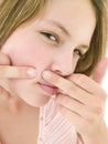 Teenage girl popping zit on face Royalty Free Stock Photo
