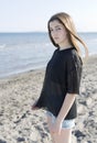 Teenage girl posing on the beach.