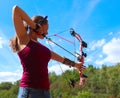 Teenage girl practices archery on a warm, summer day Royalty Free Stock Photo