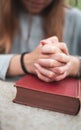 Teenage girl praying at home , hands on bible. concept of faith & hope Royalty Free Stock Photo