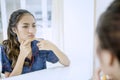 Teenage girl pressing pimples on her face Royalty Free Stock Photo