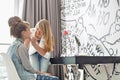 Teenage girl putting lipstick on sister at home Royalty Free Stock Photo