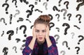 Teenage girl and question marks falling Royalty Free Stock Photo