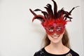 Cheerful girl with venetian feather mask