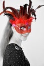 Cheerful girl with venetian feather mask