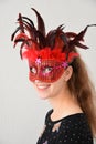 Cheerful girl with venetian feather mask