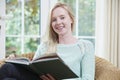 Teenage Girl Relaxing And Reading Book At Home Royalty Free Stock Photo