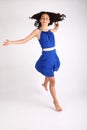 Teenage girl running with flying hair in blue dress Royalty Free Stock Photo