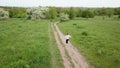 A teenage girl runs on a footpath in a field.